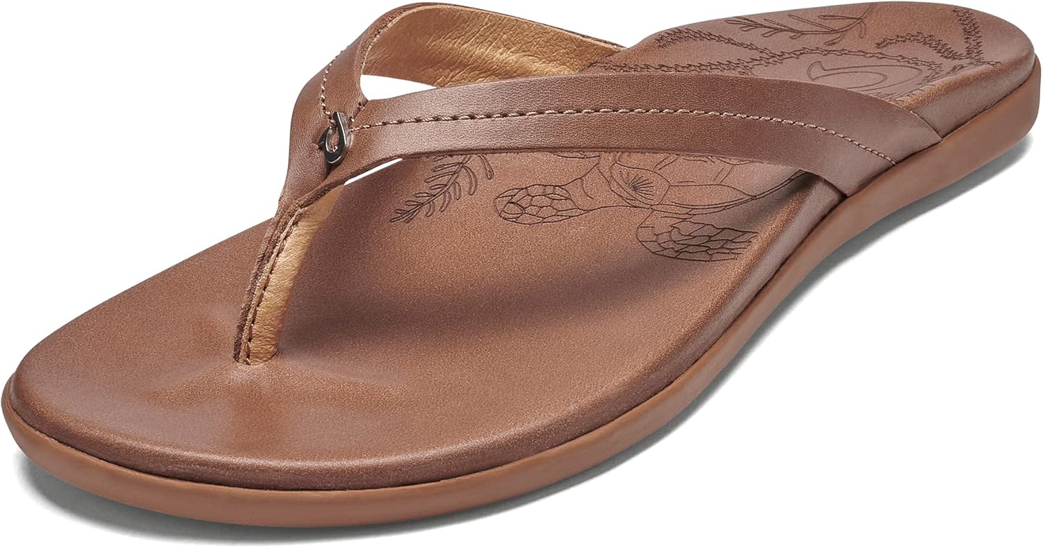 OLUKAI Honu women's beach sandal in tan full-grain leather, featuring a soft slip-on design with cushioned footbed for all-day comfort — view 1