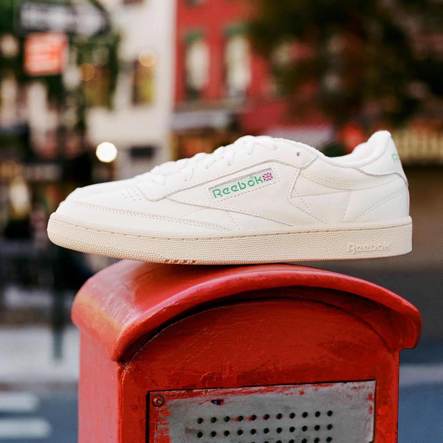 Reebok men's classic leather sneaker in white and navy, featuring the iconic side stripe and cushioned sole for all-day comfort โ view 3