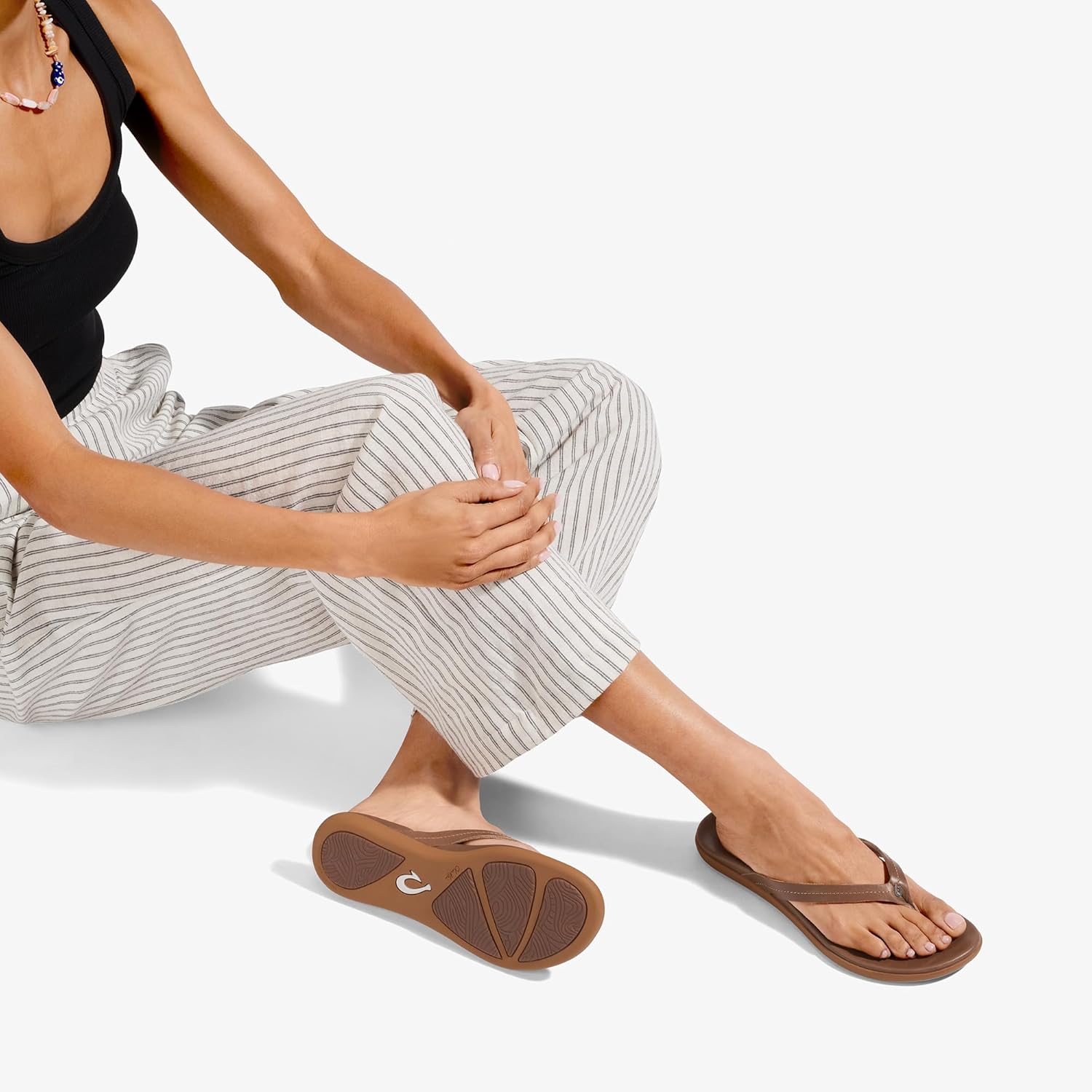 OLUKAI Honu women's beach sandal in tan full-grain leather, featuring a soft slip-on design with cushioned footbed for all-day comfort — view 2
